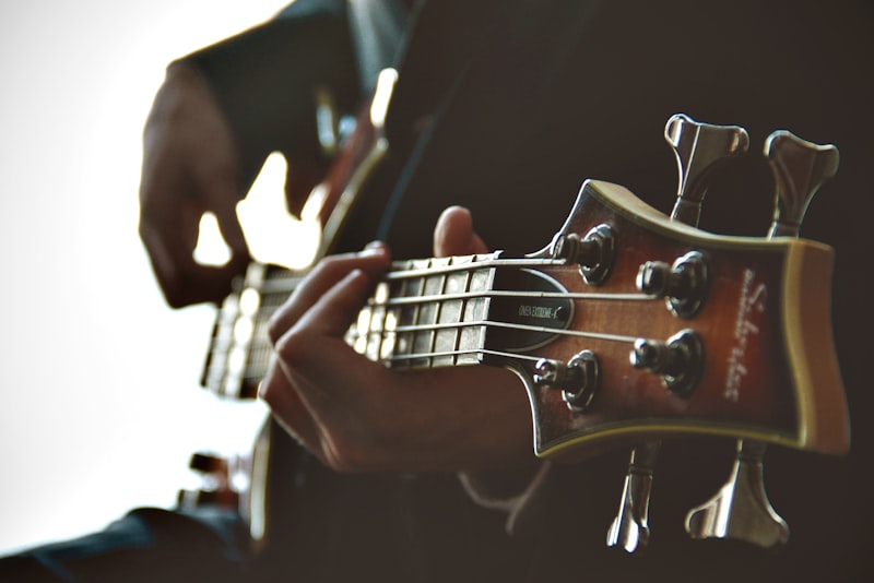 Hands playing chords on an electric piano in a softly lit home studio